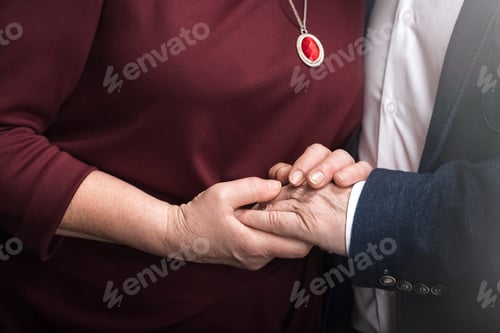 Preview: Close-up partial view of senior couple holding hands