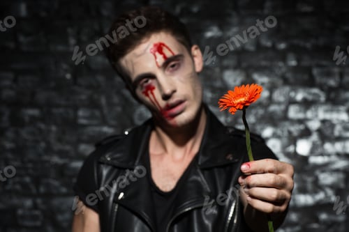 Preview: Emotionless male zombie giving a gerbera flower