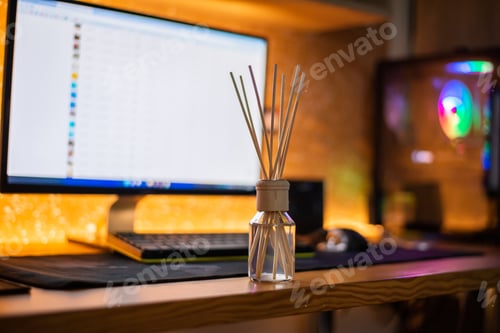 Preview: reed diffuser glass bottle is on the wood table with computer to creat romantic and relax ambient.