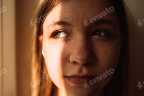 Preview: A close-up portrait of a cute teenager against the wall.