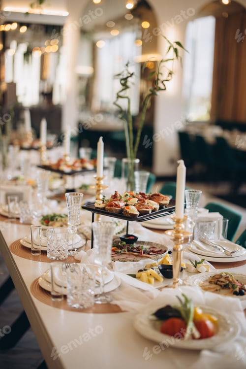 Preview: Elegant wedding table setting with appetizers, candles and flowers