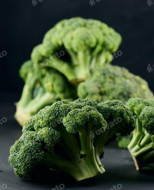 Preview: Fresh green head of broccoli on black background