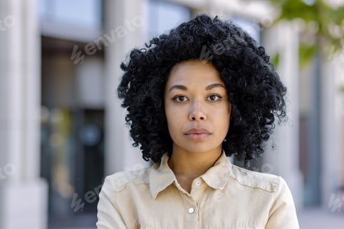 Preview: Close-up portrait of young serious thinking woman outside office building, business woman with