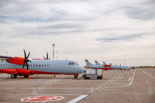 Preview: Passenger airplanes and private jets parked at airfield