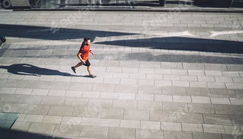 Preview: Fit male jogger running on street in city