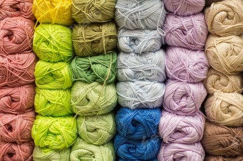 Preview: Selection of colorful yarn wool on shopfront. Knitting background. Knitting balls of wool