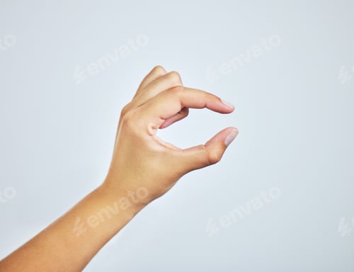 Preview: Studio shot of a woman gesturing a small size with her hand against a grey background