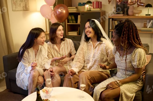 Preview: Diverse Young Women Sharing Laughter with Bride during Festive Gathering
