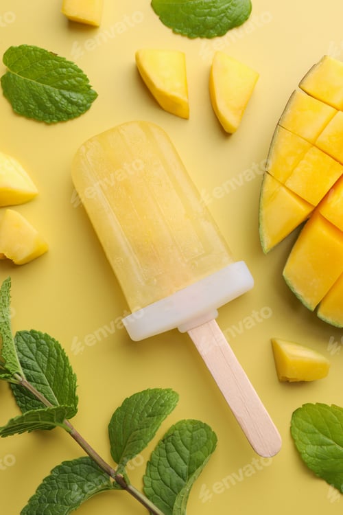 Preview: Tasty mango ice pop on light yellow background, flat lay. Fruit popsicle
