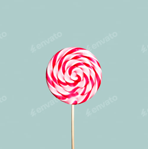 Preview: Colorful pink and white lollipop on pastel vintage blue background.