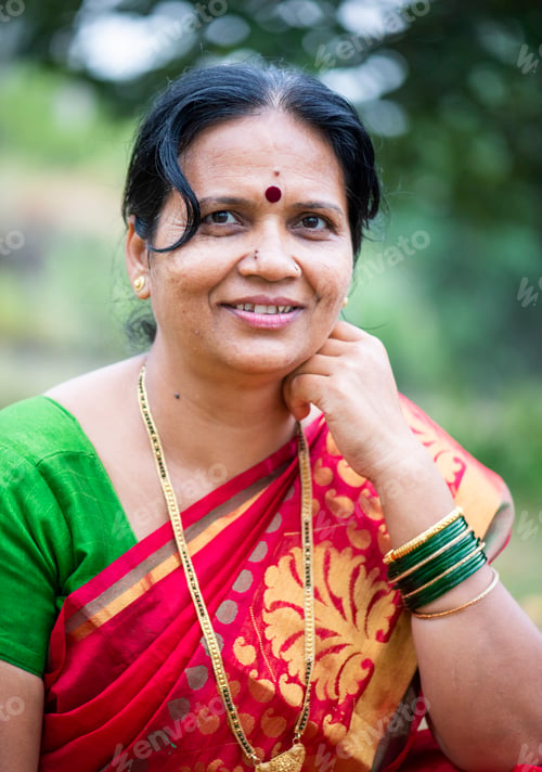 Preview: Happy Indian woman in traditional clothes at outdoor.