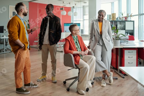 Preview: Diverse Team Engaging in Discussion in Modern Office