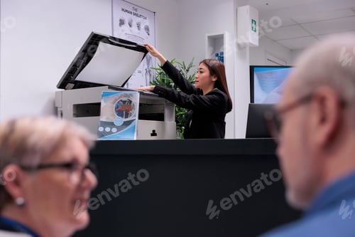Preview: Secretary using copy printer at reception counter