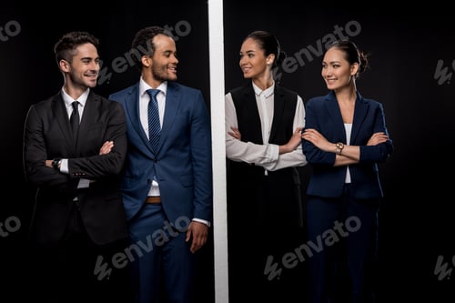 Preview: Confident businessmen separated by wall with smiling businesswomen isolated on black