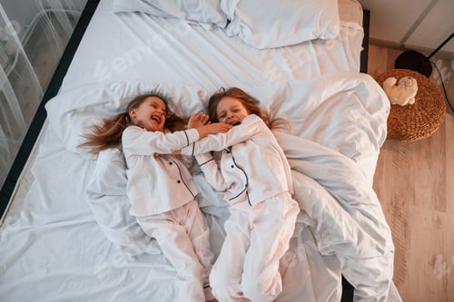 Preview: Two little girls are playing and having fun together in domestic room