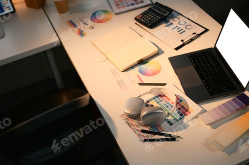 Preview: Creative designer workspace with color swatches, color wheel charts, and laptop