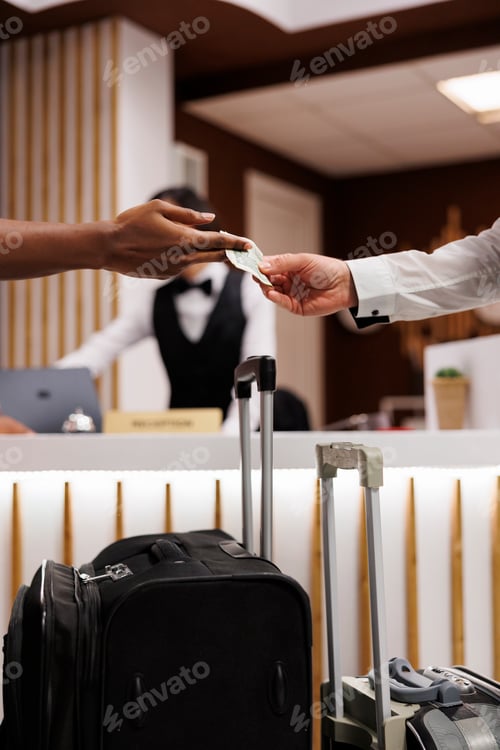 Preview: Person giving money to porter in lobby
