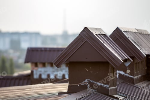 Preview: Close-up detail of new built brick plastered chimneys