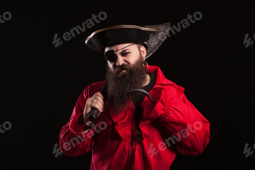 Preview: Angry man in a pirate capitan costume for halloween holding and axe on his shoulder