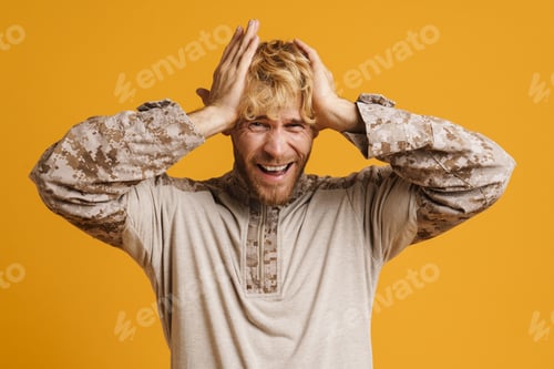 Preview: European military man with headache holding his head