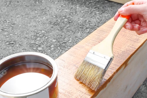 Preview: Painting wooden products with a brush and paint products outdoors