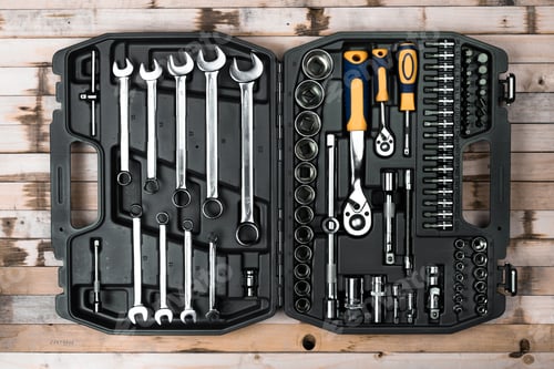 Preview: Tool set arranged neatly in a black case on a wooden surface showcasing a variety of wrenches and