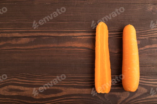 Preview: Orange Carrot on brown wooden, Top view, copy space