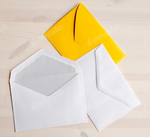 Preview: Three envelopes lying on wooden table
