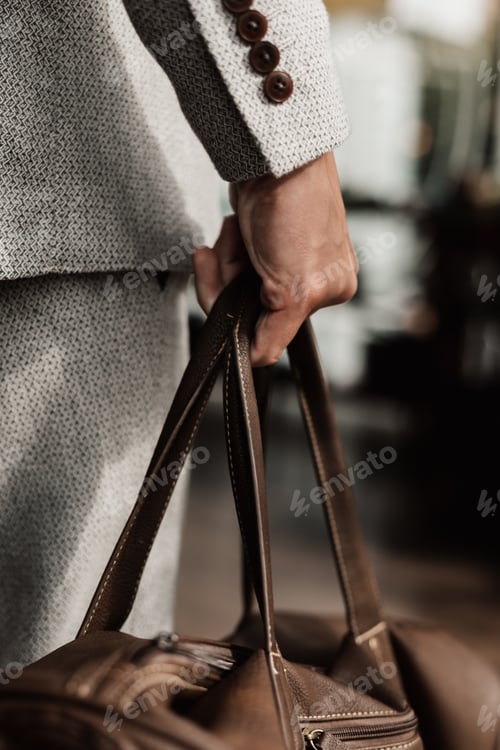 Preview: man's hand holding a bag
