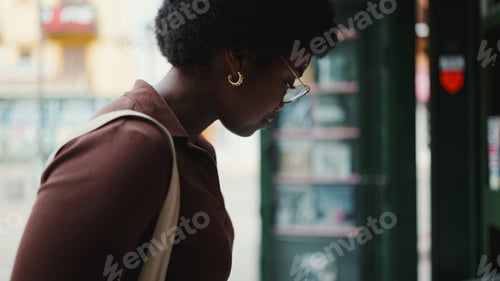 Preview: Beautiful brunette woman looking dreamy outdoors, wearing glasse