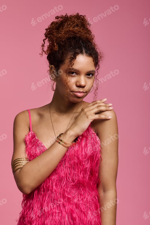 Preview: Young woman in vibrant pink outfit shares a playful moment against a pink background