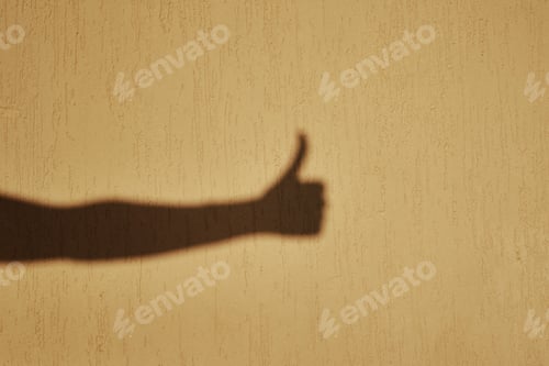 Preview: Thumb up gesture shadow on wall