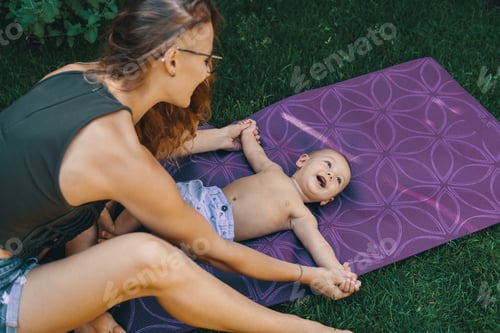 Preview: Mother doing baby yoga for her son