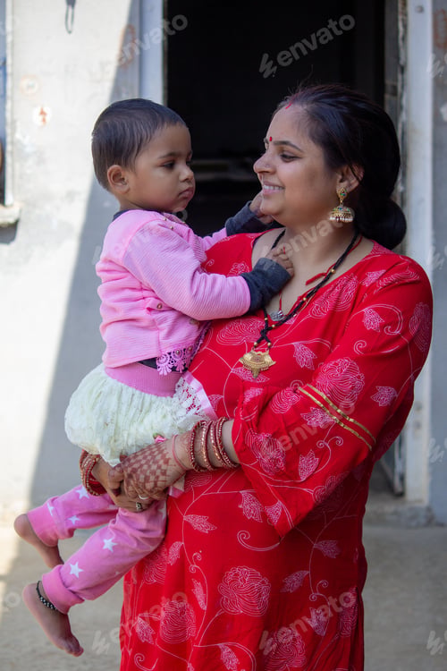 Preview: Indian mother and child in traditional attire outdoors