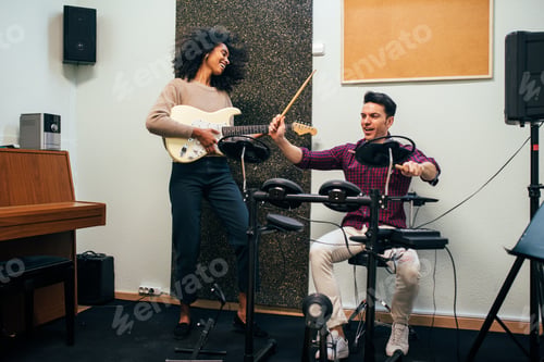 Preview: Man playing guitar and woman playing drums
