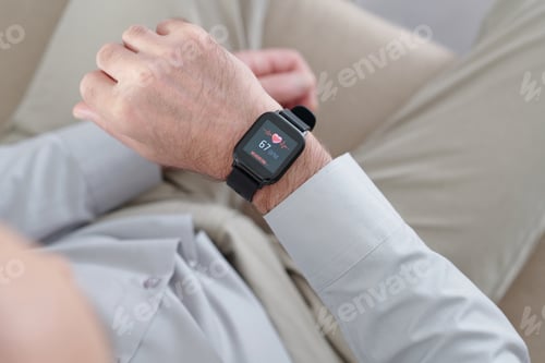 Preview: Man Looking at Screen of Smartwatch