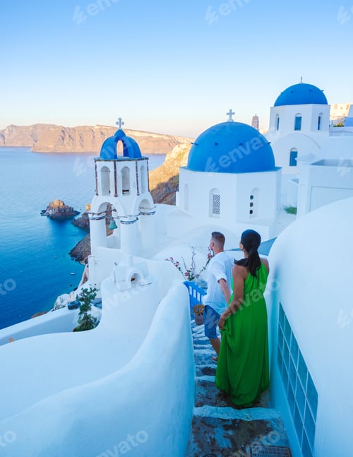 Preview: Couple walking at the Greek village of Oia Santorini Greece, men and women on vacation in Greece