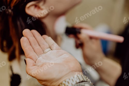 Makeup Artist Applying Powder to Woman's Face