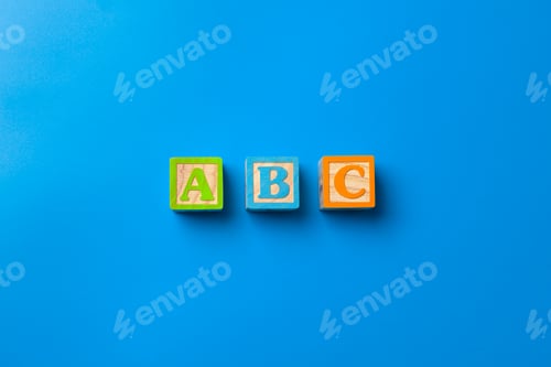 Preview: Abc. Wooden colorful alphabet blocks on blue background, flat lay, top view