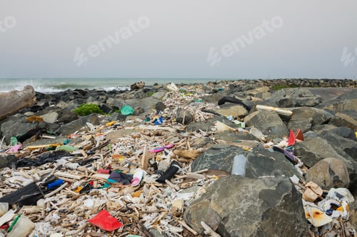Preview: Spilled garbage on the beach near the big city.