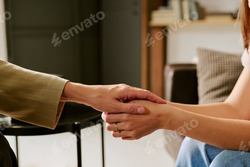 Preview: Middle Aged Caucasian Woman Holding Hand of Young Caucasian Woman Comforting