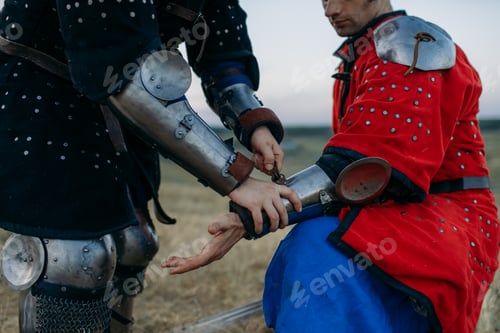 Preview: Medieval knight helps his friend to put on armor