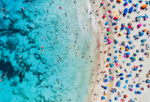 Preview: Aerial view of sandy beach with umbrellas and sea