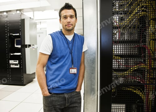 Preview: Portrait of a caucasian male technician in a large server room.