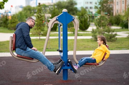Preview: Cute girl with her dad on the sports field.