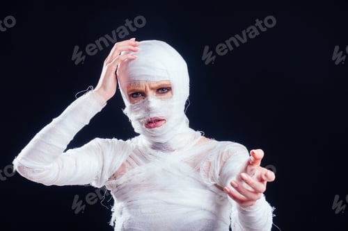 Preview: Glamorous mummy woman in bandages all over her body studio black background