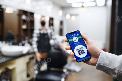 Preview: Client showing vaccination certificate in barber shop, coronavirus and new normal concept