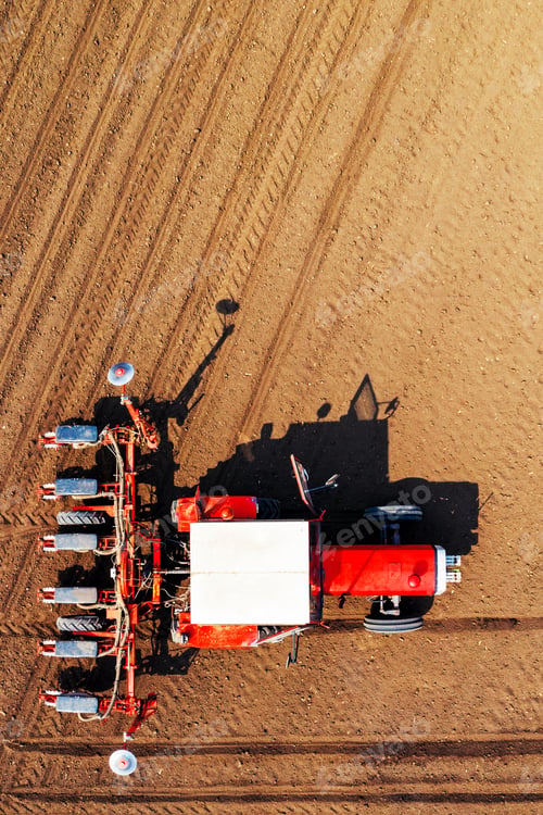 Preview: Top view of tractor with seeder from drone pov