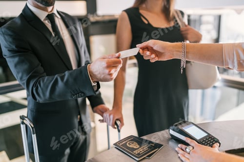 Preview: Business people makes card payment at check-in at reception.