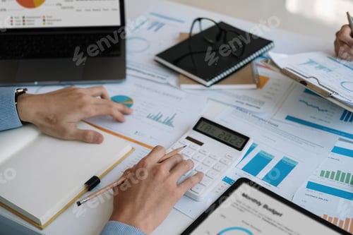 Preview: Close up Businessman and partner using calculator and laptop for calculating finance, tax